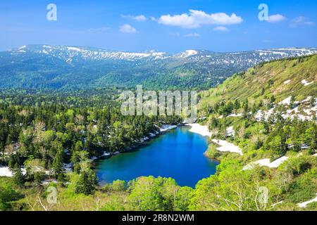 Kumanuma in Hachimantai-daira and a mountain range with lingering snow Stock Photo