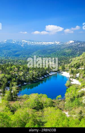 Kumanuma in Hachimantai-daira and a mountain range with lingering snow Stock Photo