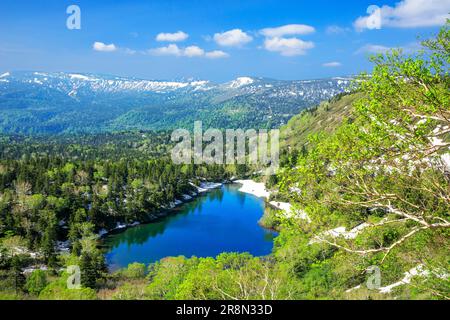 Kumanuma in Hachimantai-daira and a mountain range with lingering snow Stock Photo