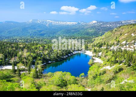 Kumanuma in Hachimantai-daira and a mountain range with lingering snow Stock Photo