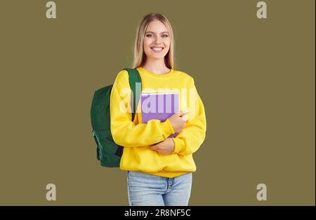Beautiful young student with a backpack and textbooks. Stock Photo