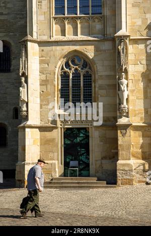 man walking past St. Paul's Cathedral, Muenster, North Rhine-Westphalia, Germany. Mann geht am der St. Paulus Dom vorbei, Muenster, Nordrhein-Westfale Stock Photo