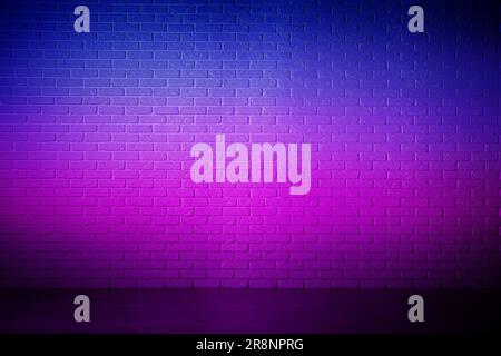 Room with brick wall and wooden floor in neon lights Stock Photo