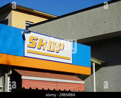 shop sign with a CCTV camera installed on the wall Stock Photo