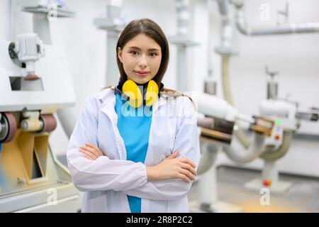 Portrait of female technician looking at camera with arm crossed Stock Photo