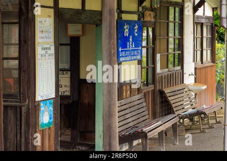 Hyogo, Japan - May 15, 2023: Signs and empty benches at historic unmanned station in rural Japan Stock Photo