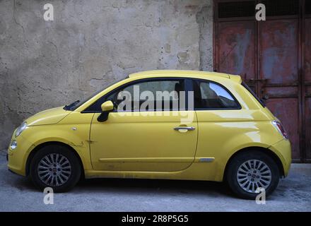 Yellow Fiat 500 on the streets of Agrigento in Sicily, Italy. Stock Photo
