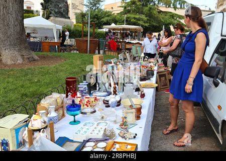 ALTAMURA, ITALY - JUNE 4, 2017: People visit flea market in Altamura, Italy. Variety of trinket and antique furniture. Stock Photo