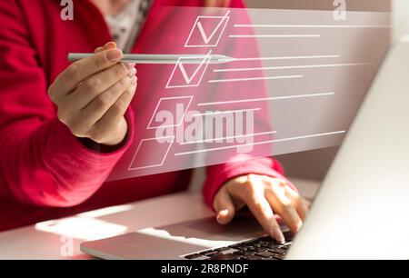 Paperless workplace idea, e-signing, electronic signature, document management. A businesswoman signs an electronic document on a digital document on Stock Photo