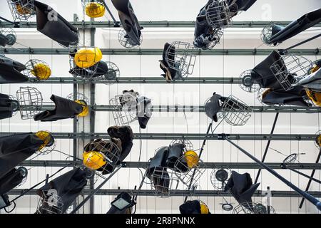 Scenic bottom view old abandoned coal mine worker clothing dressing room hanged at ceiling with chain lockers. Historical industrial mining museum Stock Photo