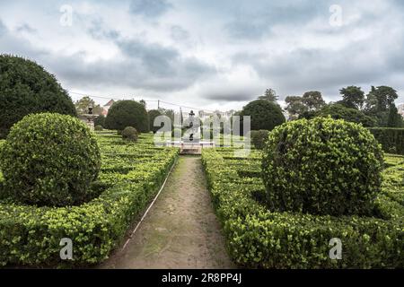 Park with decorative green bushes and maze on a cloudy day in Lisbon, Portugal Stock Photo
