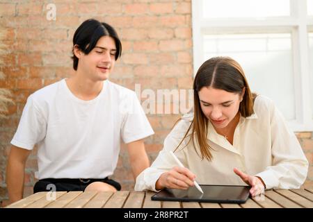 Couple of happy young people spending time together at home on weekend Stock Photo