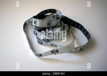 White dimmed measuring tape for tailors or diets. Stock Photo