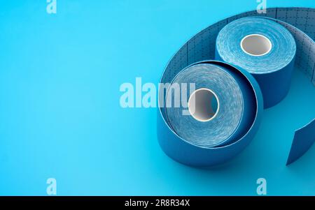 Rolls of Colorful Kinesiology or Physio Tape Isolated on Blue Background With Copy Space Concept for Supportive Athletic Care, Enhancing Physical Flex Stock Photo