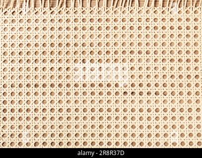 Embossed background of large-weave rattan stems. Stock Photo