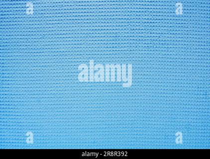 Abstract bright blue background from textured soft waffle fabric. Stock Photo