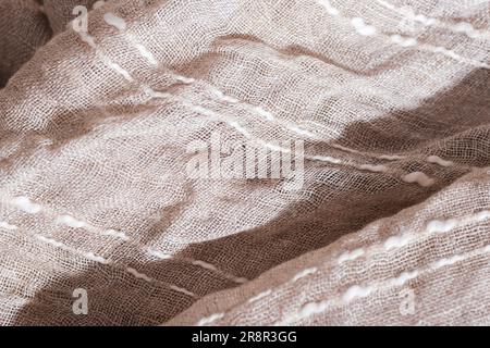 Beige cotton crumpled fabric with stripes. Light and shadows. Texture, background. Stock Photo