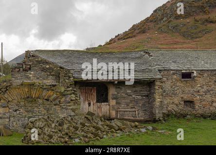 Broken down old farm building with collapsed roof Stock Photo