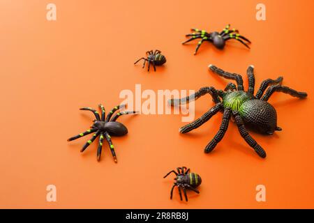 Group of black toy spiders on a orange background for halloween Stock ...