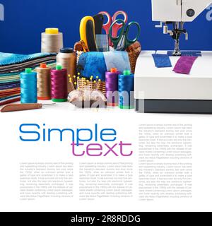 Sewing accessories in a basket and spools of threads next to sewing machine Stock Photo