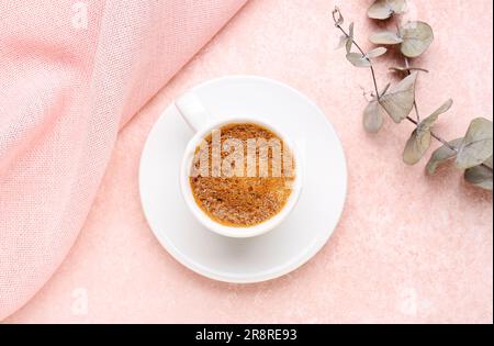 Cup of hot espresso and eucalyptus on pink background Stock Photo