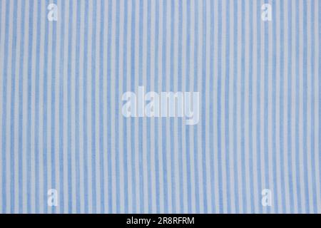 The background is striped cotton fabric in blue and white. Stock Photo