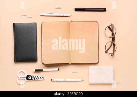 Notebooks with different stationery on pale orange background Stock Photo