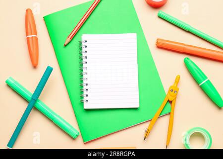 Notebooks with different stationery on pale orange background Stock Photo