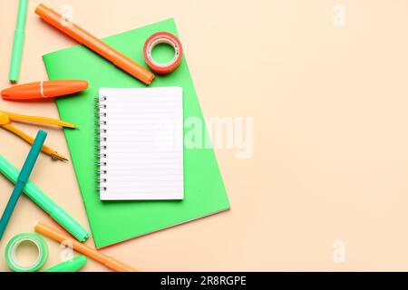 Notebooks with different stationery on pale orange background Stock Photo