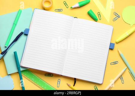 Notebooks with different stationery on pale orange background Stock Photo