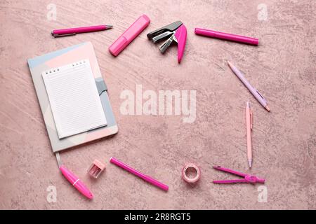 Notebooks with different stationery on grunge pink background Stock Photo