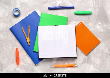 Notebooks with different stationery on grunge white background Stock Photo