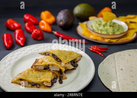 quesadilla with chicken meat and beans and guacamole with nachos Stock Photo