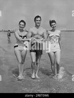 Film Festival Fun -- A happy trio enjoying themselves in The Lido at Vanice, where they are attending the Film Festival, are (left to right) Italian actress Irene Genna, Richard Todd and 16-year-old Janette Scott, when film 'Now and Forever' is being shown during the Festival. A delegation from the Associated British film studios at Elstree is now in Venice for the 1955 International Film Festival taking place there. The party includes stars Richard Gray, together with director Mario Zampi. In their 'off duty' time, the stars are taking full advantage of the festival and are enjoying them… Stock Photo