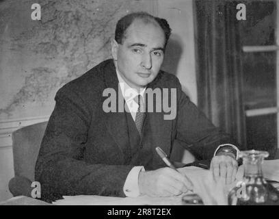 Britain's New Minister Of Food -- Mr. John Strachey, at his desk in the Ministry of Food, Portman Court, London, after taking up his appointment. Mr. John Strachey, former Parliamentry Under-Secretary of State for Air, has been appointed Minister of Food upon the resignation of Sir Bon Smith. Mr. Geoffrey de Freitas, M. P., takes over the office of Uner-Secretary of State for Air. Mr. Strachey, who is 44, has been an outstanding success among junior ministers, and his early promotion was expected. Educated at Eton and Oxford, and heir to the baronetcy of Strachio, his reputation before on… Stock Photo