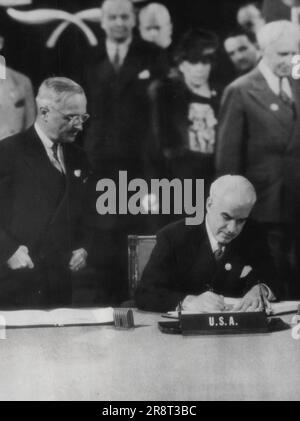 President Harry Truman, seated, signs bill which brings employees of ...