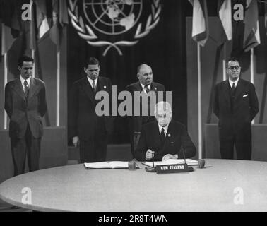 Peter Fraser, Prime Minister of New Zealand, signs the United Nations security chapter at San Francisco. July 30, 1945. (Photo by Associated Press Photo). Stock Photo
