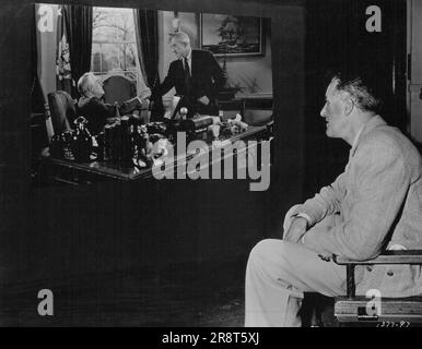 Portrait Of A President .... After a world-wide search, Godfrey Tearle, American-born actor who rose to fame in British theatrical circles, was chosen because of his remarkable likeness to portray the late President Roosevelt, in Metro- Goldwyn-Mayer's gripping story of the atom bomb, 'The Beginning or the End.' Here he is shown as he spends his first day at the studio. Brian Donlevy and Robert Walker are starred in the film, with Tom Drake, Beverly Tyler, Audrey Totter, Hurd Hatfield, Hume Cronyn and others in the outstanding cast. Norman Taurog directed, Samuel Marx produced. Seeing him… Stock Photo