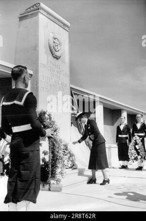 The Duchess Lays a Wreath -- Wearing her uniform as Chief Commandant of the Women's Royal Naval Service, the Duchess of Kent lays a wreath on a memorial to officers and man of the Fleet Air Arm, which she unveiled at a ceremony here. The memorial had been built by the Imperial War Graves Commission to commemorate the men who laid down their lives during the war and who have no grave but the sea. May 20, 1953. (Photo by Planet News Ltd.). Stock Photo