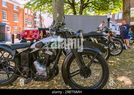 A vintage Royal Enfield motorcycle lines up with other motorbikes at a classic and vintage motor show. Stock Photo