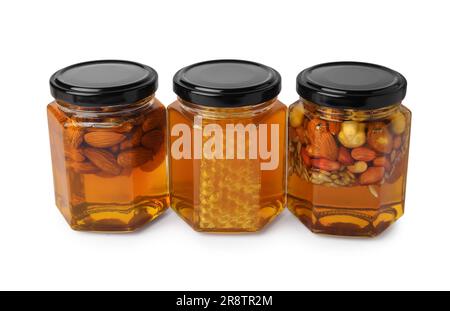 Jars with different nuts and honey on white background Stock Photo