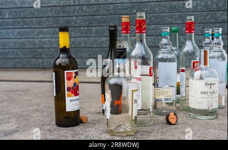 Various of alcohol empty bottles. Glass bottles of alcohol on the floor. Street photo, nobody-Toronto, Canada-June 16,2023 Stock Photo