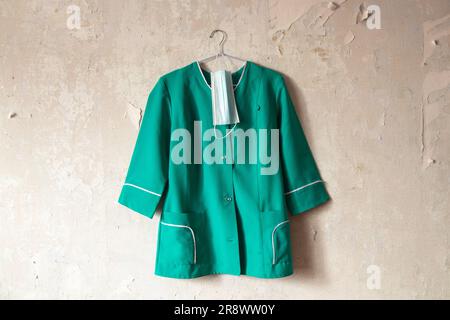 Ukraine nurse costume hanging on a white old wall in a house Stock Photo