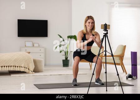 Fitness trainer recording online classes at home Stock Photo