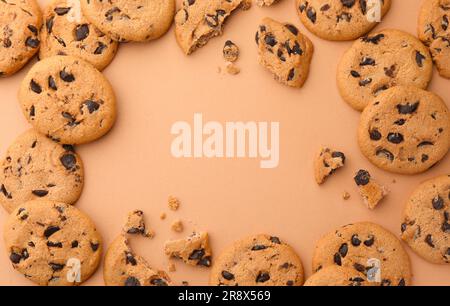 Frame made of many delicious chocolate chip cookies on beige background, flat lay. Space for text Stock Photo