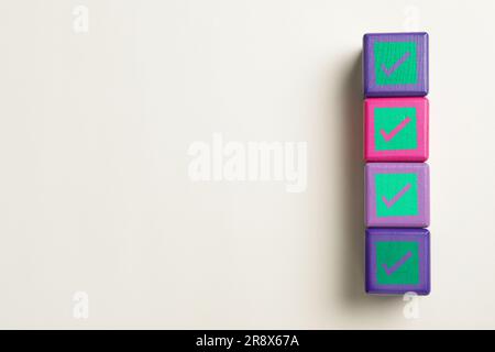 Check Mark Cube Cubes with check marks on beige background, top view. Space for text ...