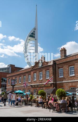 Gunwharf Quays in Portsmouth on a sunny summer June day with people sitting outside the Old Customs House pub, Hampshire, England, UK Stock Photo