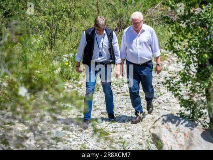 Bischkek, Kyrgyzstan. 23rd June, 2023. German President Frank-Walter Steinmeier (r) hikes through Kyrgyzstan's Ala Archa National Park and learns about the geological consequences of climate change in Kyrgyzstan. In addition to political talks, the two-day state visit to Kyrgyzstan also includes meetings with students, a visit to a glass factory and a tour of the Ala Archa National Park. Credit: Jens Büttner/dpa/Alamy Live News Stock Photo