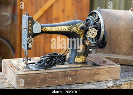 Vintage Singer sewing machine threaded with spool of white thread on white  Stock Photo - Alamy