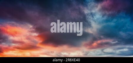 Dramatic moody colorful storm clouds in the sky at twilight Stock Photo